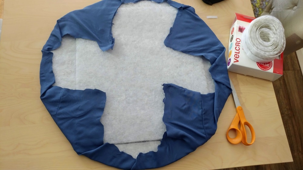 circular seat padding partially covered in blue fabric