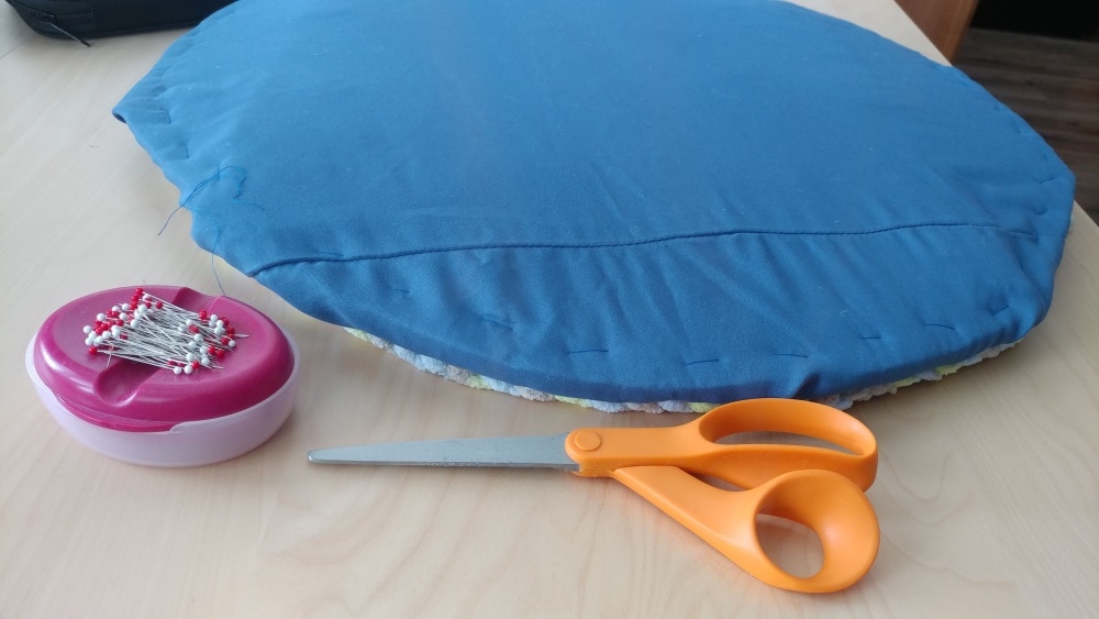 circular seat pad, scissors, and pins