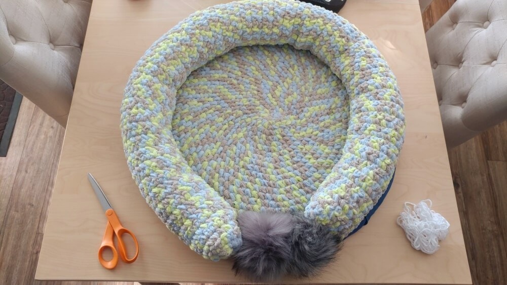 circular crochet pet bed on a table