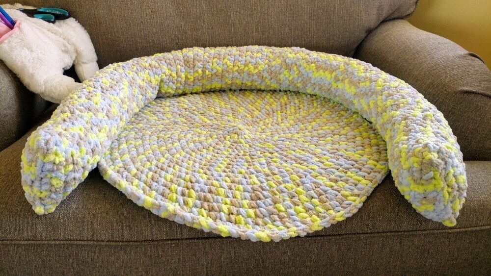 crocheted pet bed in an armchair