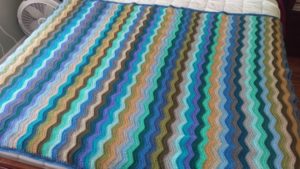 a ripple-striped blanket in coastal colors