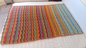 Woodland Blanket CAL - a multicolored blanket on a bed