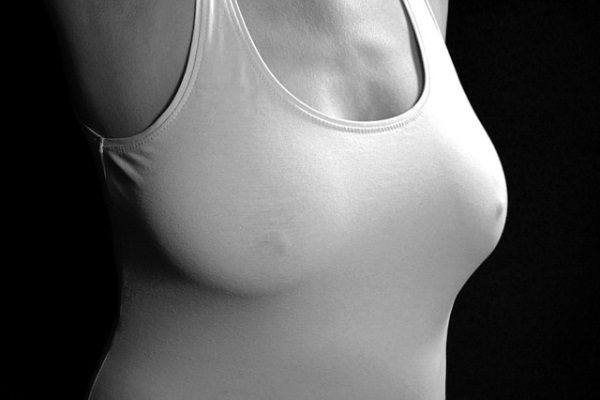 female torso in a tank top, boobs without a bra