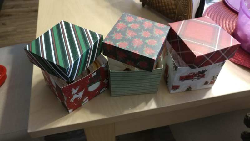 Christmas-themed boxes cut out of paper using a Cricut machine