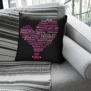 Square pillow mockup featuring a grey fabric couch, pink ribbon and a heart design made of inspiring words.